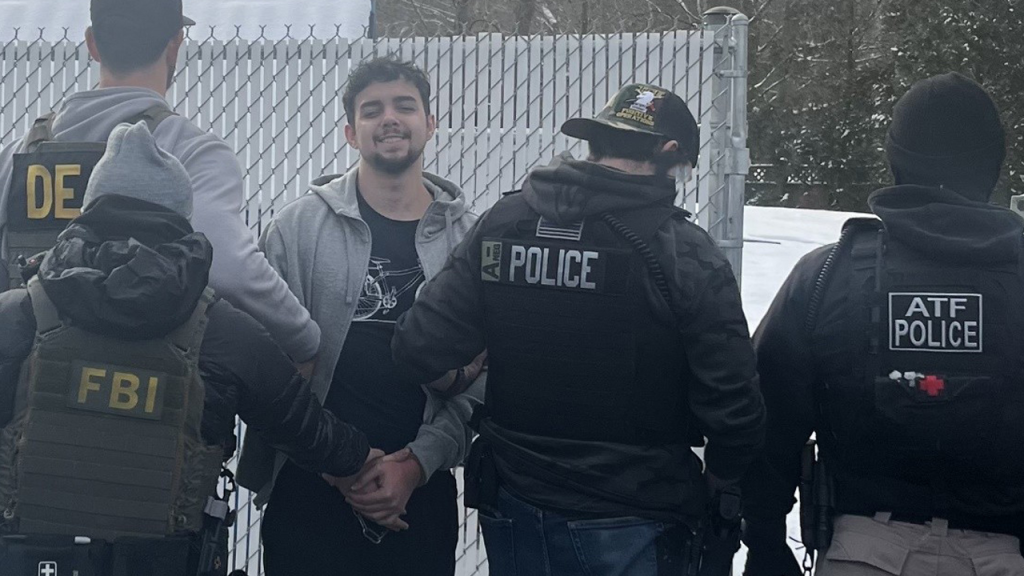 Gang Member Smiles During Arrest in Brazil