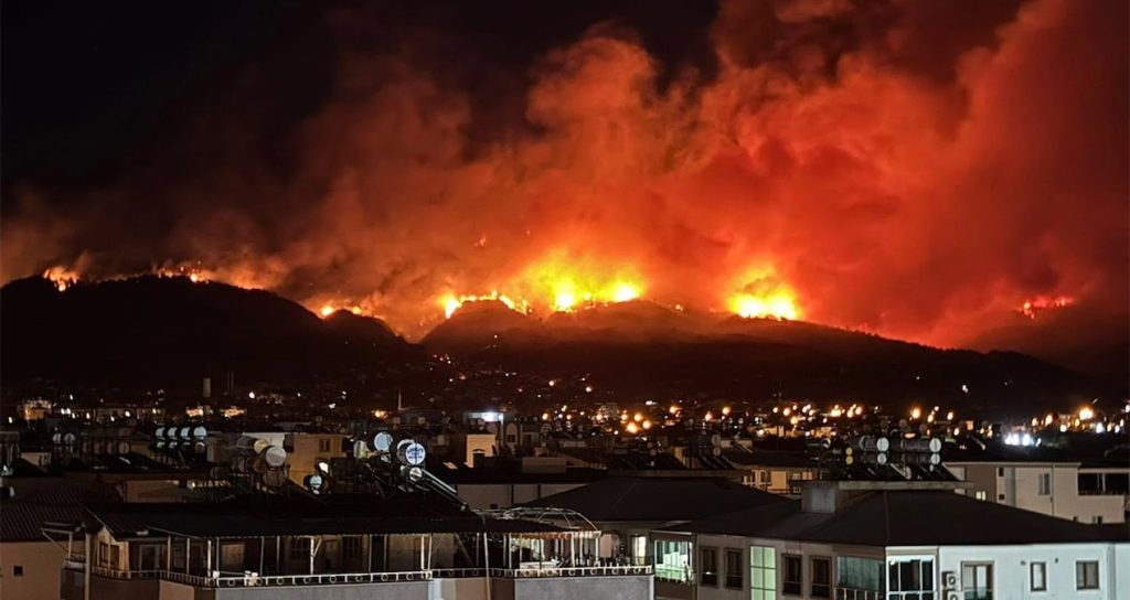 Wildfires Force Mass Evacuations in City as Flames Encroach